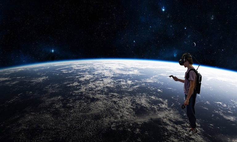 A student using virtual reality headgear to look at the world from space