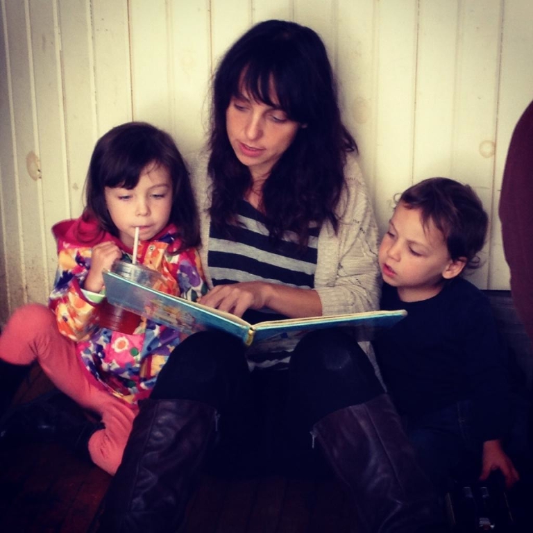 Mari Rossi reading a book to her two kids