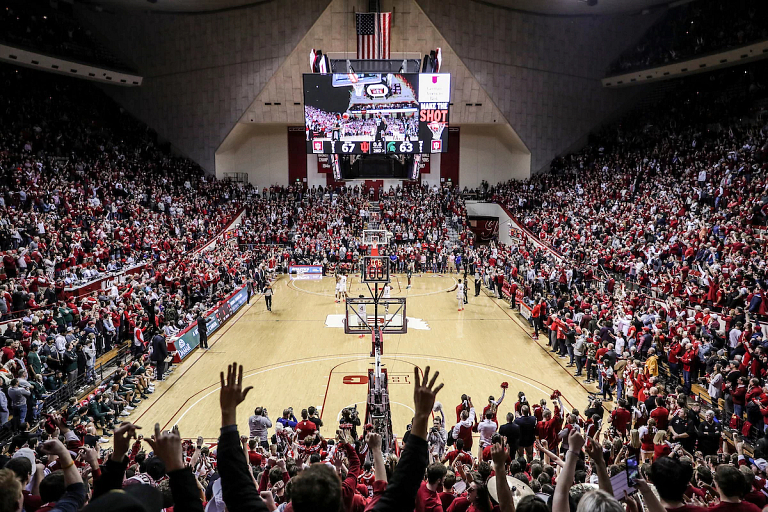 A crowd cheers during a college basketball game