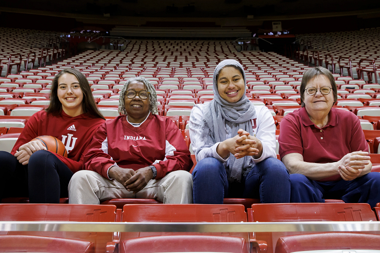 Current and former IU women's basketball players sit in Simon Skjodt Assembly Hall