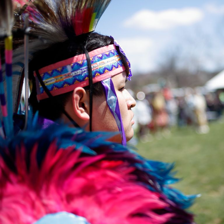 A man in a red headdress at IU's powwow