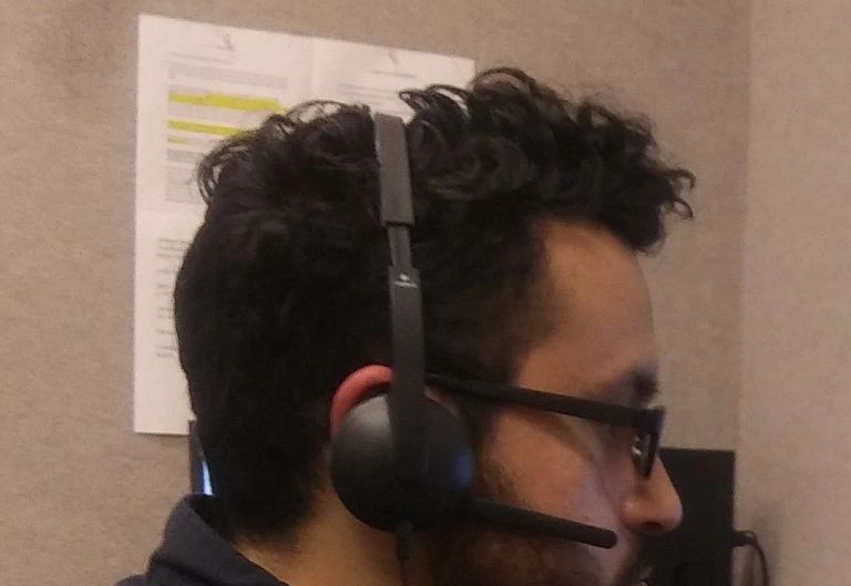 a student with a headset sits at a computer for virtual tutoring and mentoring