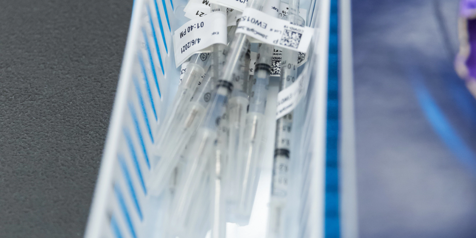 A collection of empty syringes in a white basket