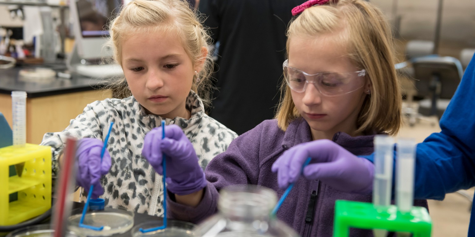 Two girls test lab experiment. 