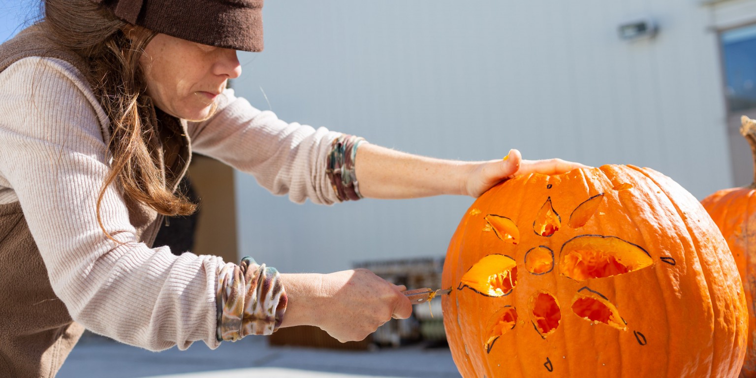 Sarah Strong carves a pumpkin.
