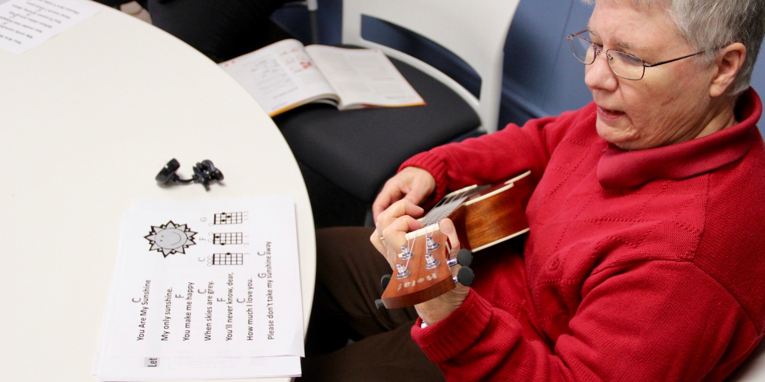 Cynthia Scott strums her ukulele.