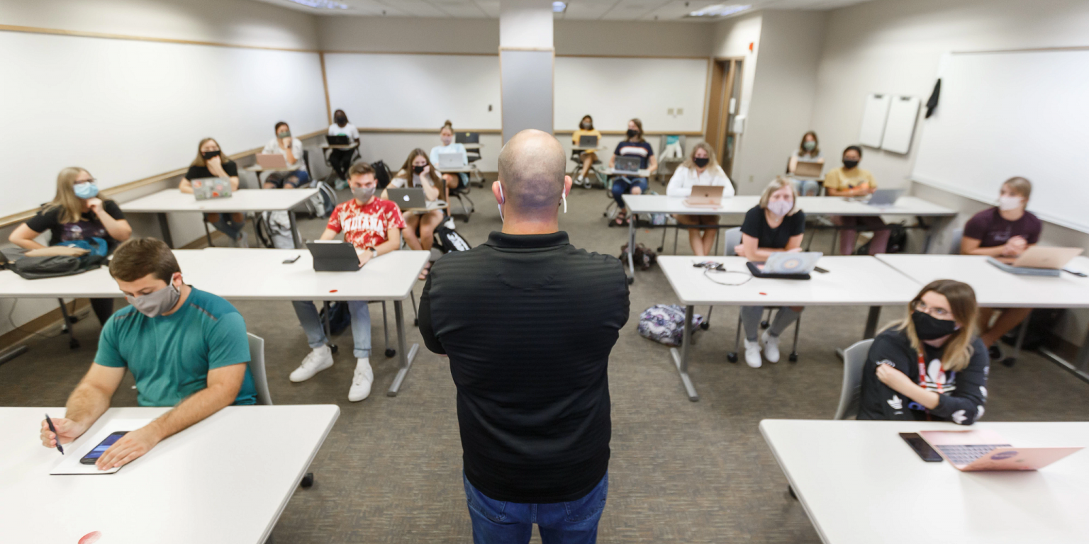 students in a classroom looking at the professor