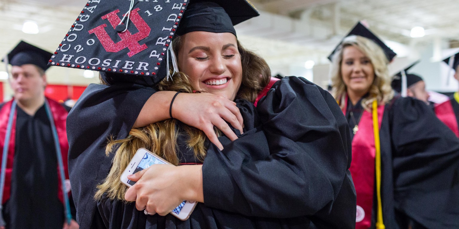 Students hug before the IU Kokomo commencement ceremony.