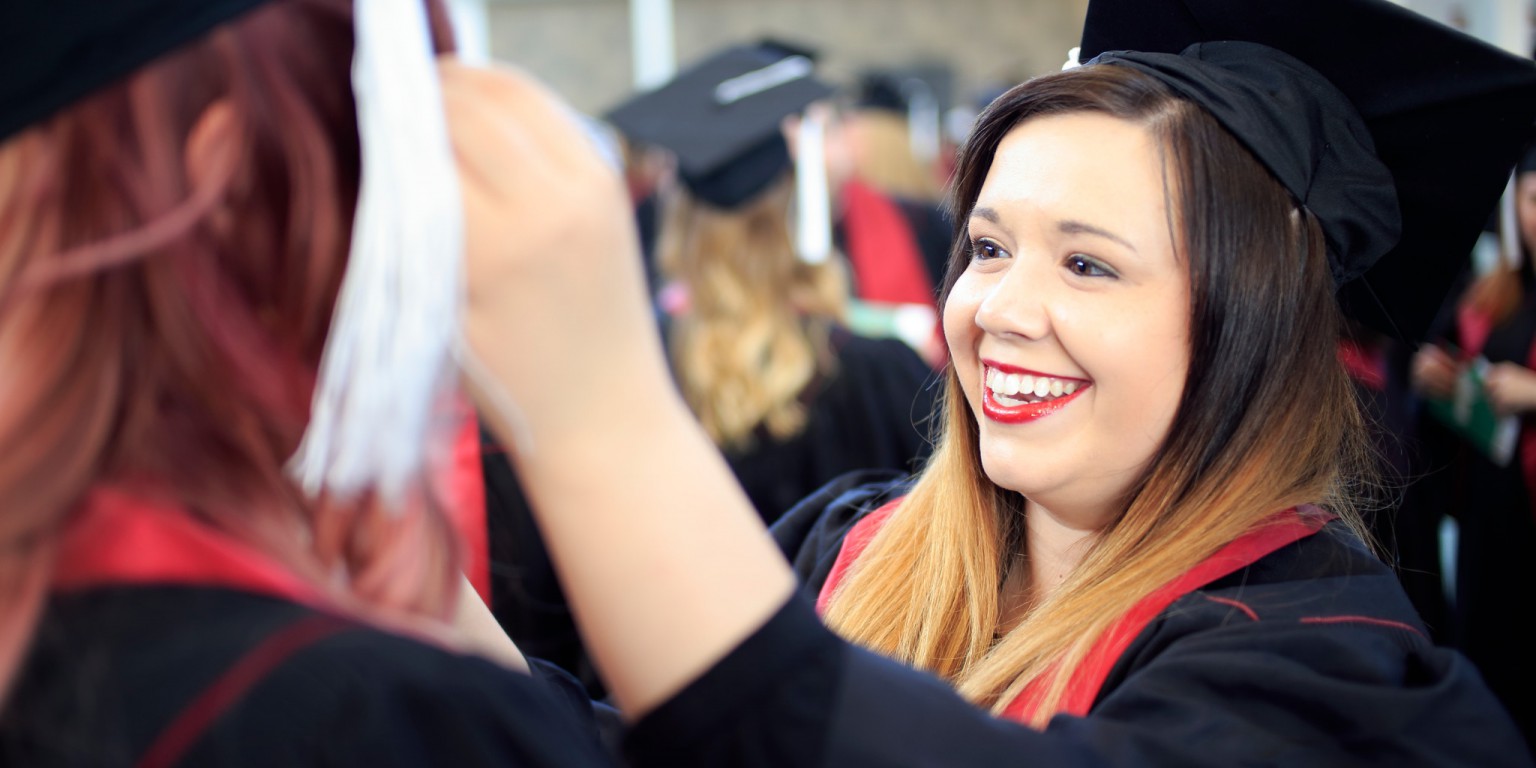 Students fix their mortarboards before the IU Southeast commencement ceremony.