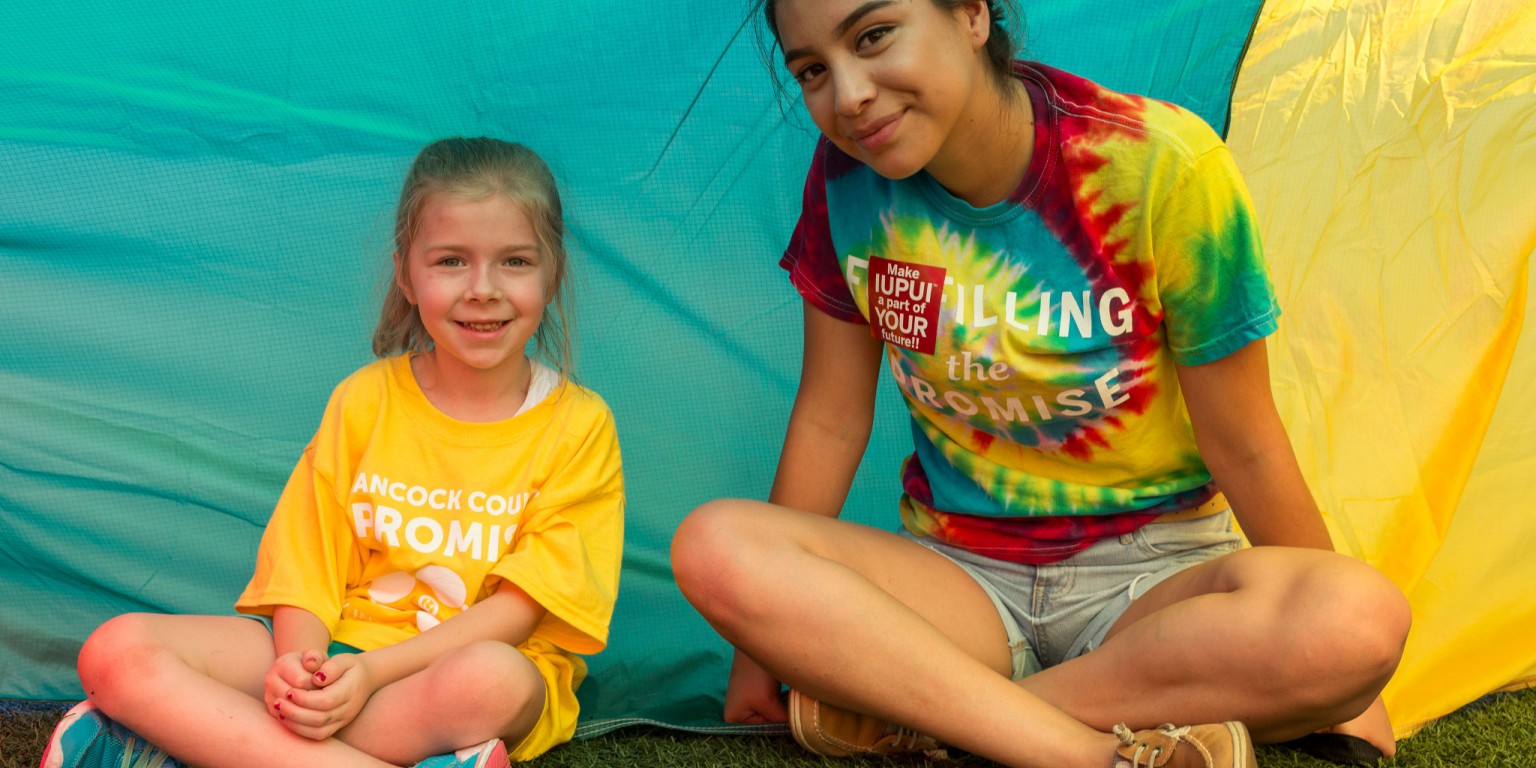 An IUPUI student and Hancock kindergartner pose for a picture.