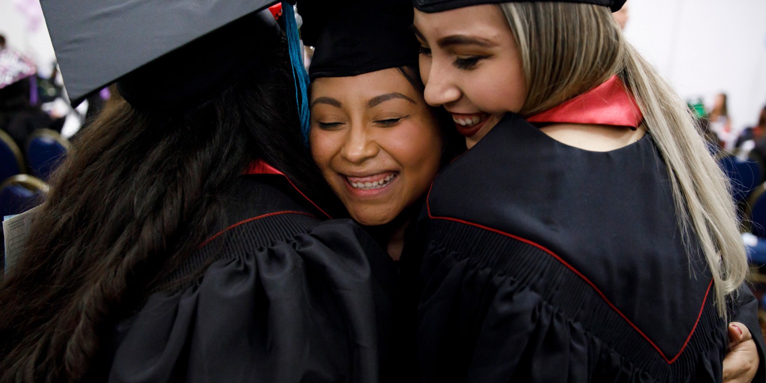 Graduate Gabriela Jaimes, center, hugs friends before the IU Northwest Commencement ceremony.