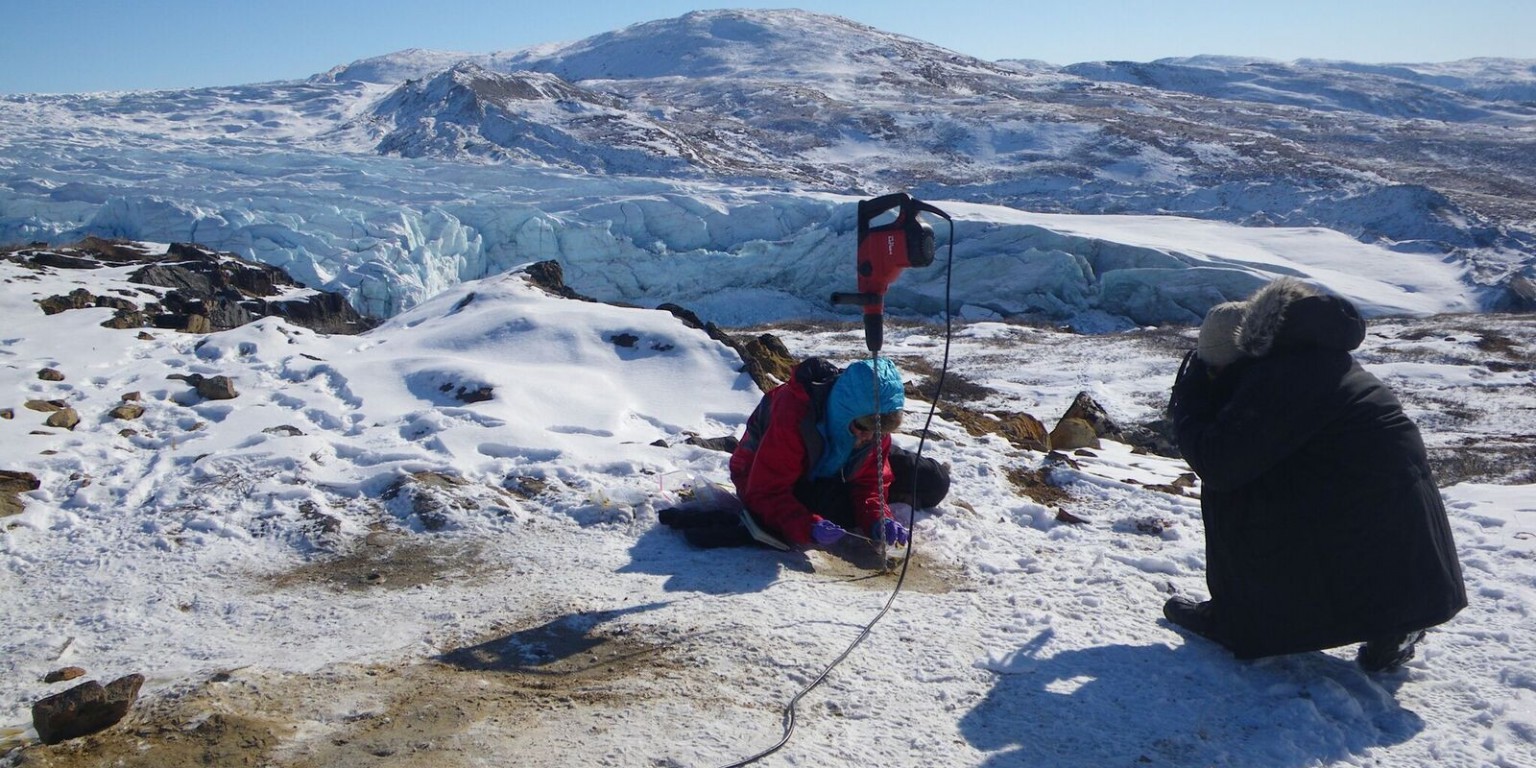 Lisa Pratt drilling holes on the Greenland ice sheet. 
