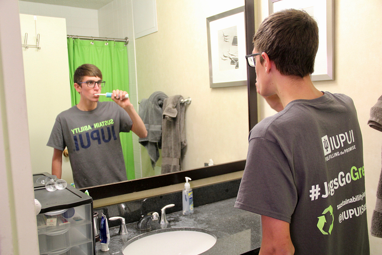 Jonathan Lewis brushes his teeth.