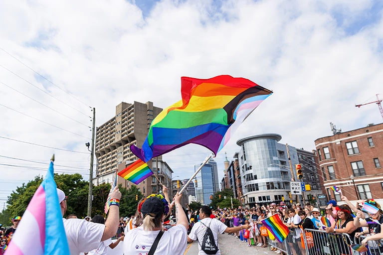 A parade-goer waves a Pride flag