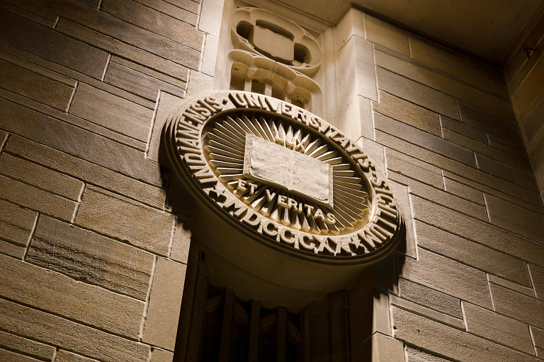 The lux et veritas seal on a limestone building