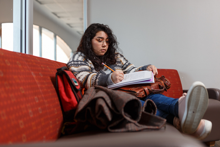 A student studies in Hine Hall.