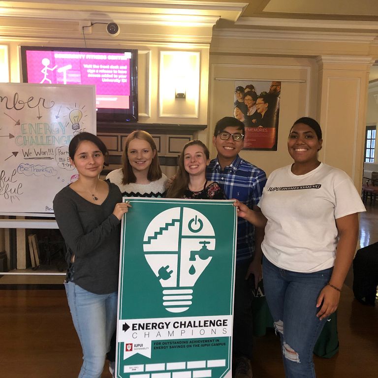 Students hold the Energy Challenge banner.