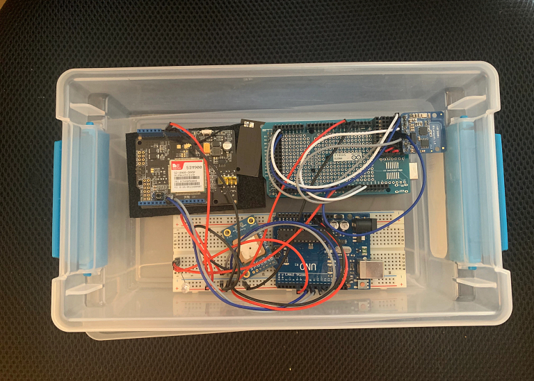 Wires connect circuit boards inside a plastic tote