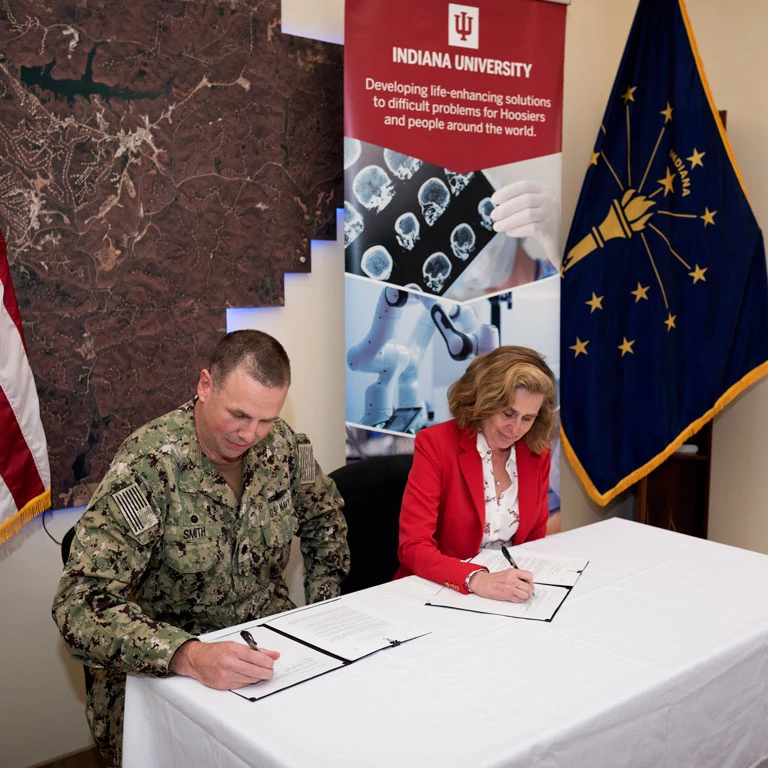 IU President Pamela Whitten and NSA Crane Commanding Officer Cmdr. James L. Smith sign an agreement