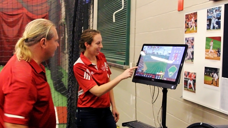 Nicholas Port and Lyndsey Ferris review information on a player's swing