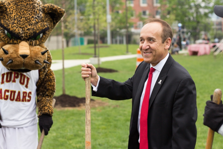 Chancellor Nasser Paydar and Jawz stand after planting a tree