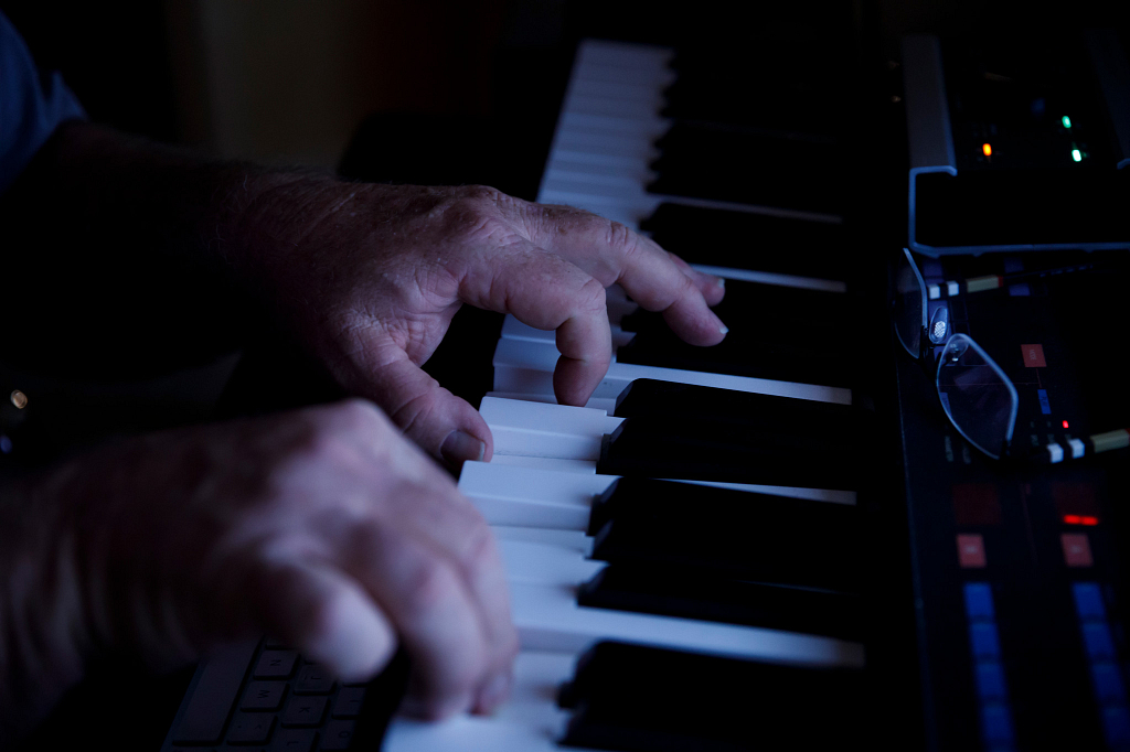 A closeup of two hands playing a keyboard