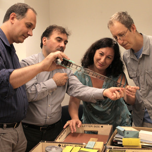 Jacobs professors Giovanni Zanovello, Giuliano Di Bacco and Halina Goldberg inspect the collection with George Lerner.