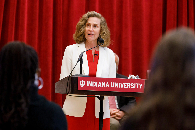 Pamela Whitten stands at a podium