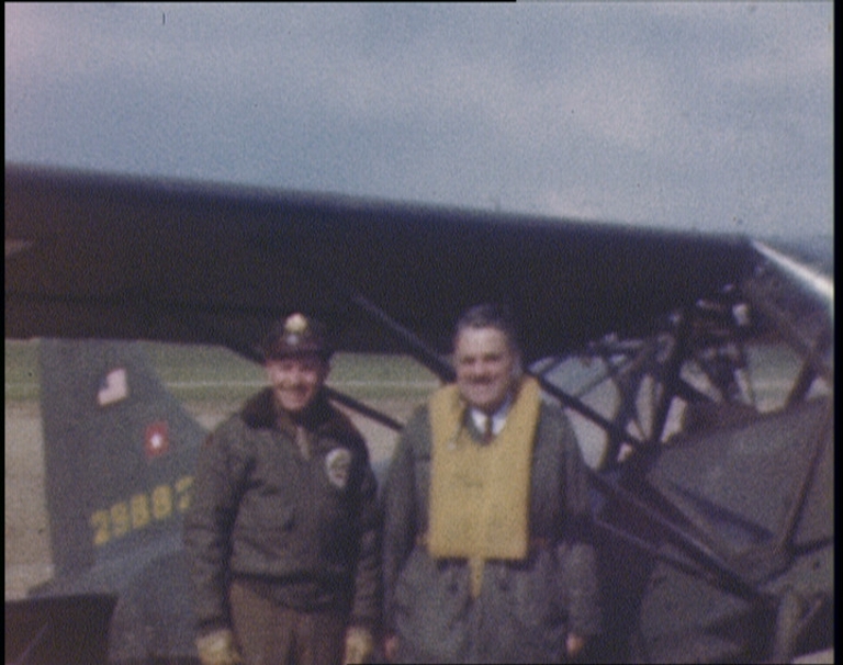 Herman B Wells standing in front of a plane with the pilot