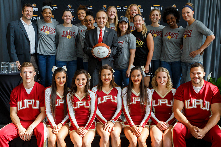 Student athletes pose with chancellor Nasser Paydar.