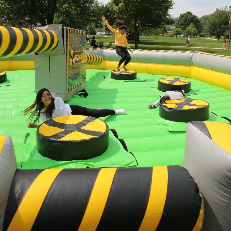 IU Northwest students jump in a Meltdown Challenge bounce house