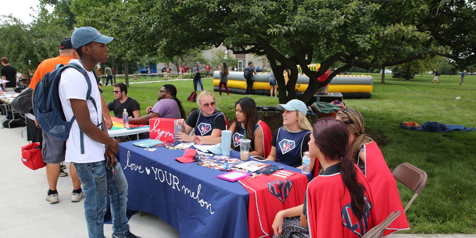 An IU Northwest student visits a booth at an activities fair