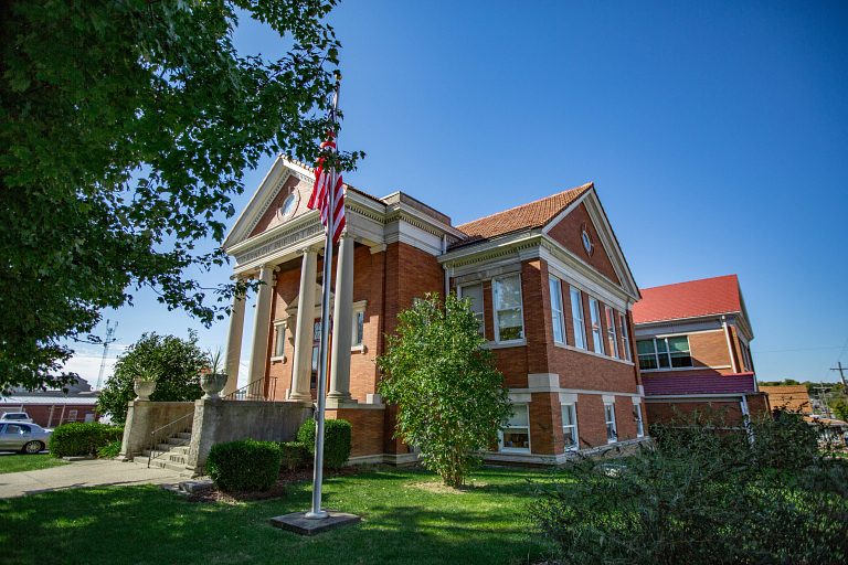 A large brick building with an American flag.
