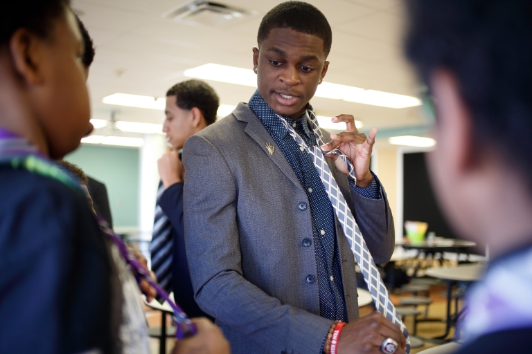 IU student DQ Manley demonstrates how to tie a tie. 