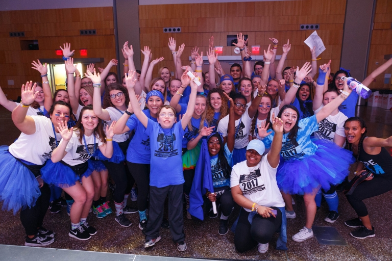 A group of IUPUI students celebrate at Jagathon with a child representing the Riley Hospital for Children.