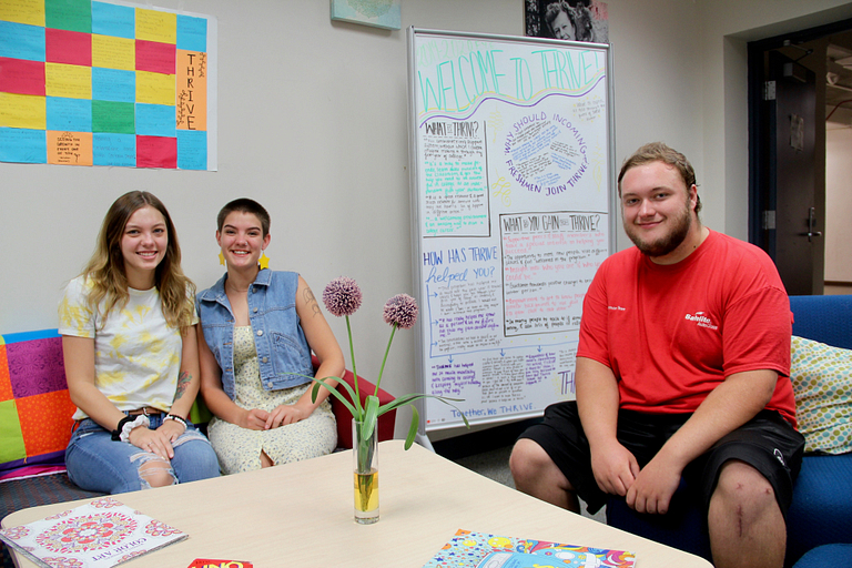 Sierra Bradway, Quentin Foltz, and Sunshine Gambill pose for a photo on campus.