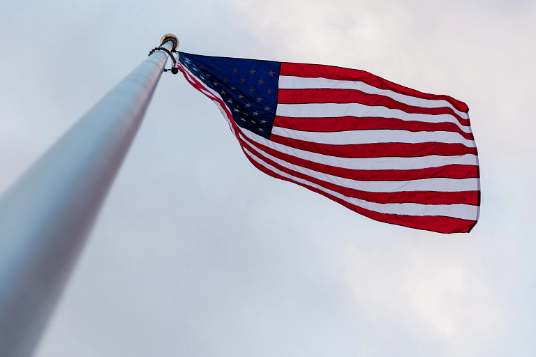 A view of the American flag from the bottom of the pole