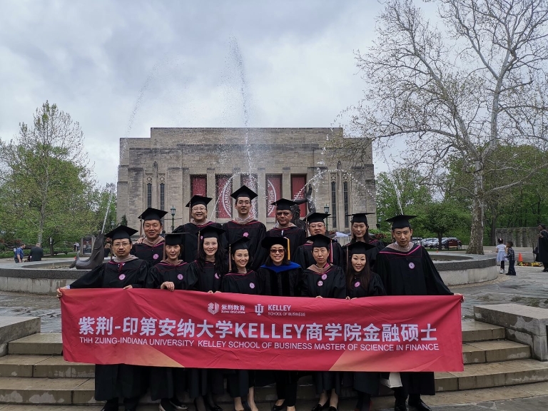 Kelley school graduates gather for a photo in front of Showalter Fountain