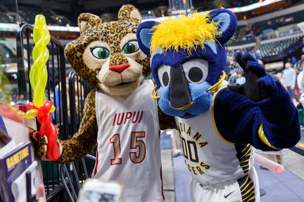 Jazzy, the IUPUI mascot, poses with Boomer, the Indiana Pacers mascot, at a Pacers game.