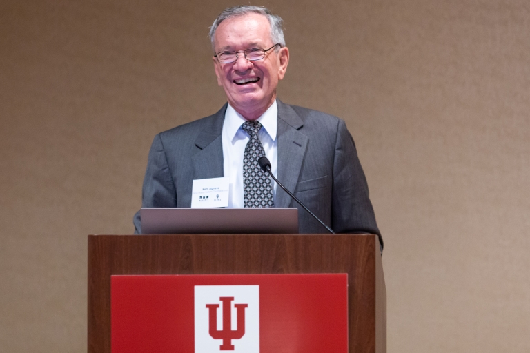 Kent Agness speaks at a podium.