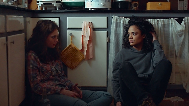 Two women sit on the kitchen floor in a scene from 'Little Woods' 