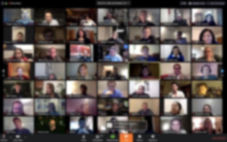 Images of many people on video screens during Zoom meeting