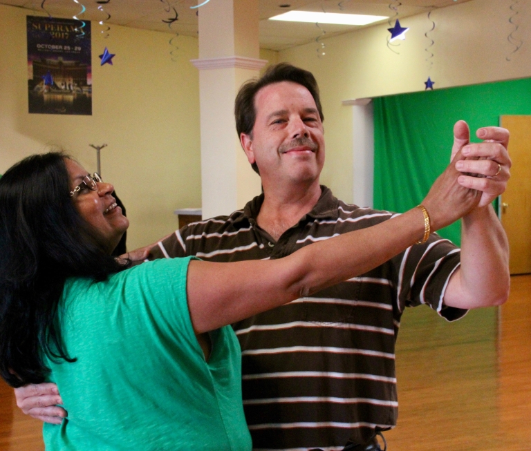 Professor Alex Dent dances with his wife, Lakshmi.
