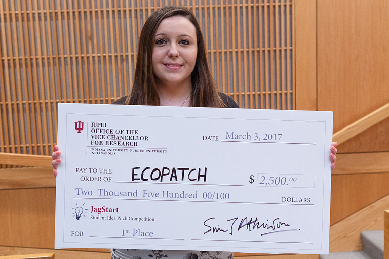 Autumn Fox poses with her giant check.