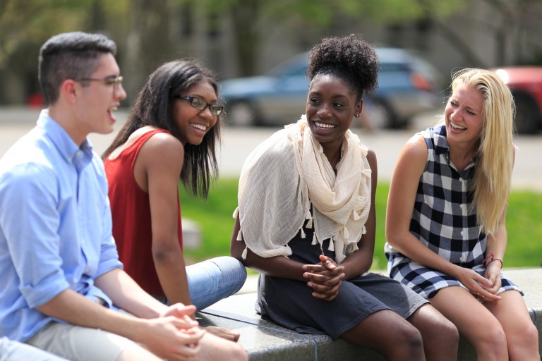 A group of students laughing outdoors