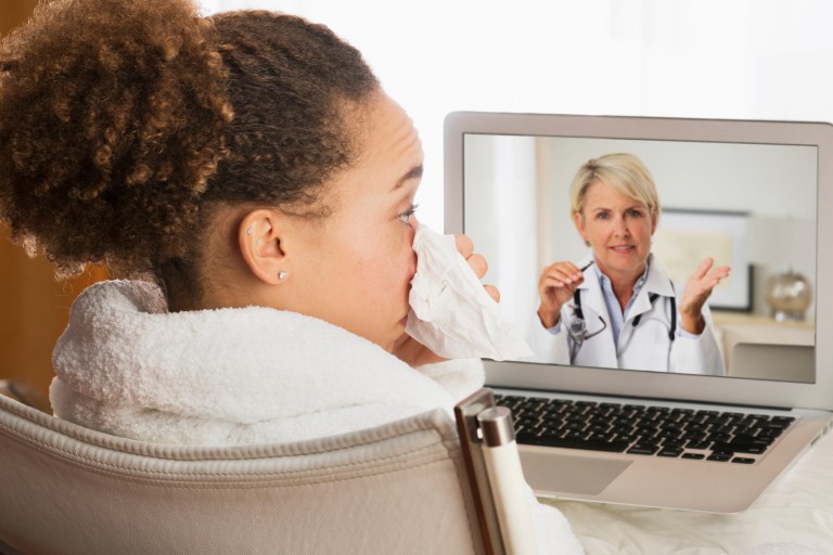 A sick woman teleconferencing with a doctor
