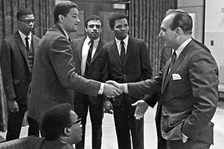 group of men, two shaking hands
