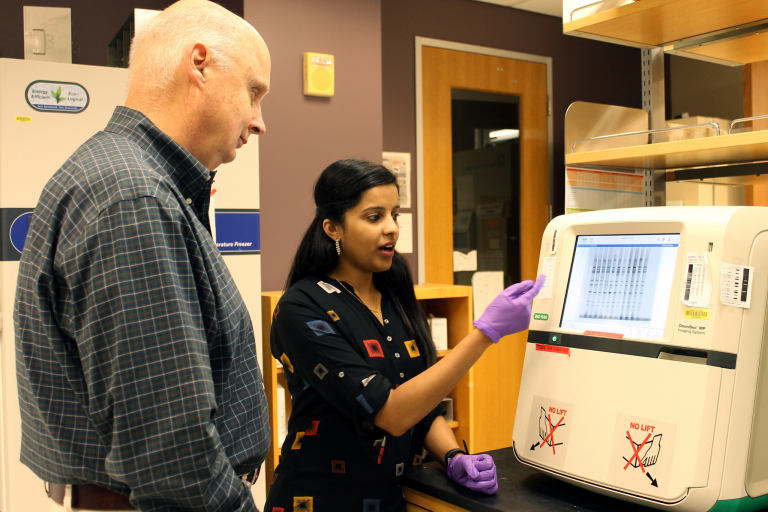 John Patton and Asha Philip working in a research lab