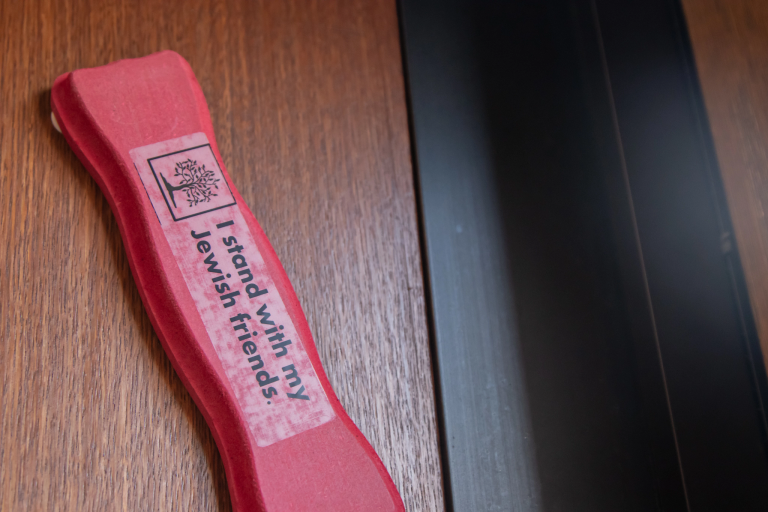 A red mezuzah says "I stand with my Jewish friends."