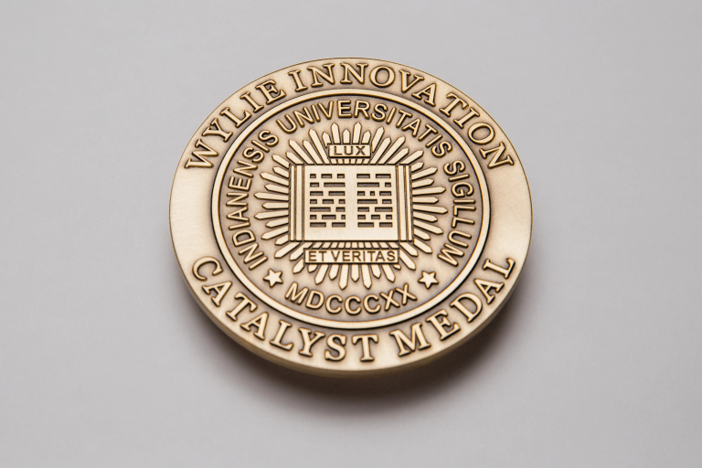 Circular gold medal that reads Wylie Innovation Catalyst Medal